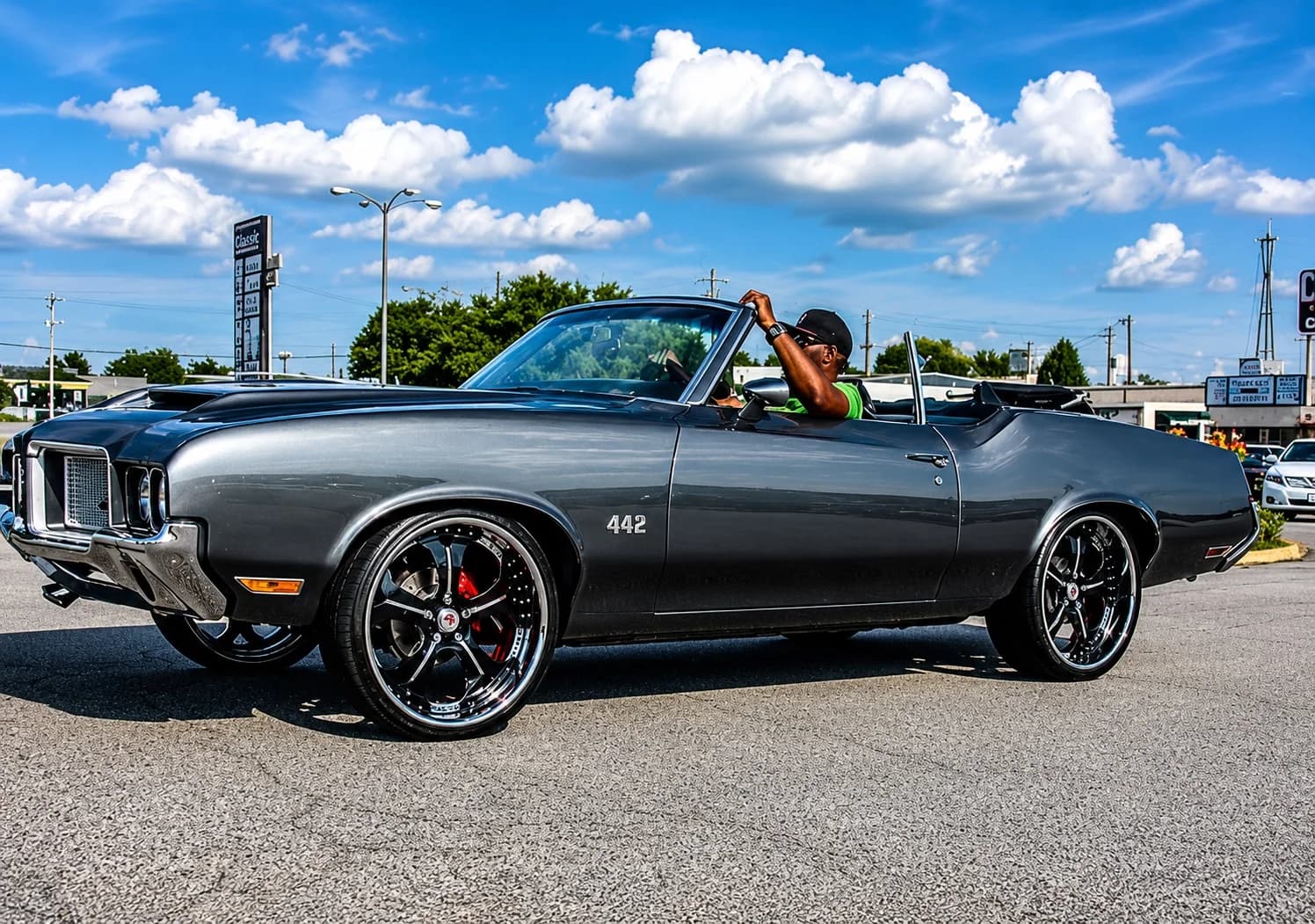 Big Lit driving his gray 1972 U-code Oldsmobile Cutlass convertible with the top down