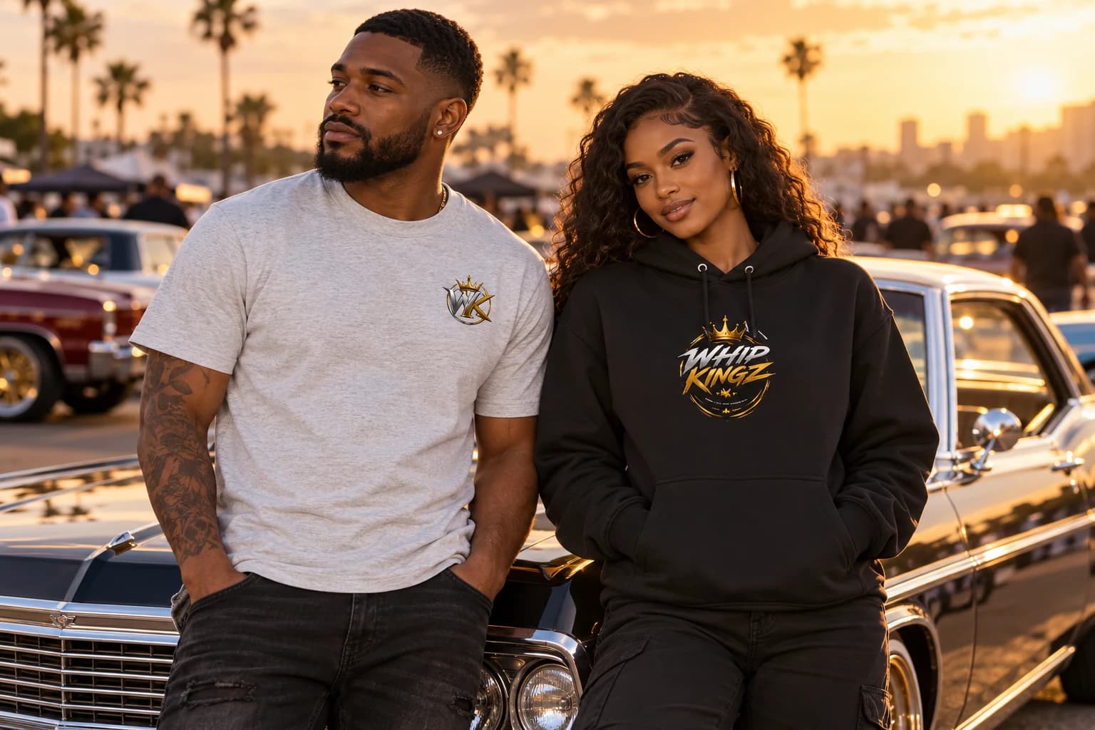 Models wearing a gray WhipKingz tee and black WhipKingz hoodie at a classic car meet