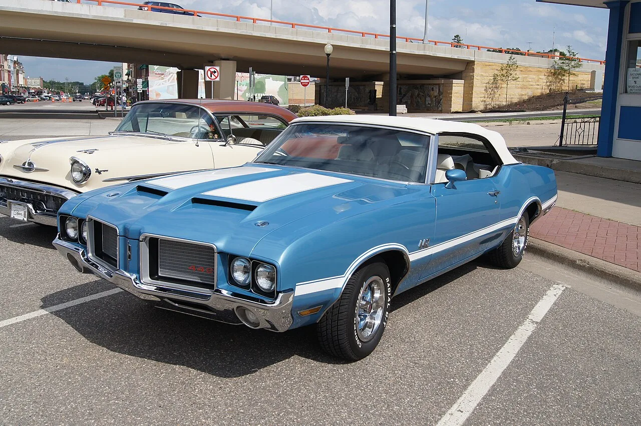 Blue 1972 Oldsmobile 442 convertible with white stripes and a white top