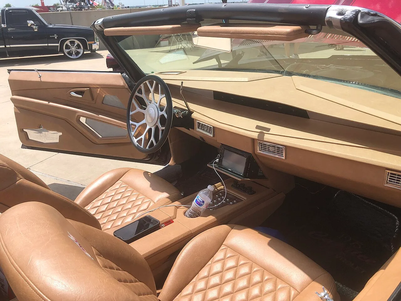Tan diamond-stitched Caprice cabin with a custom steering wheel.
