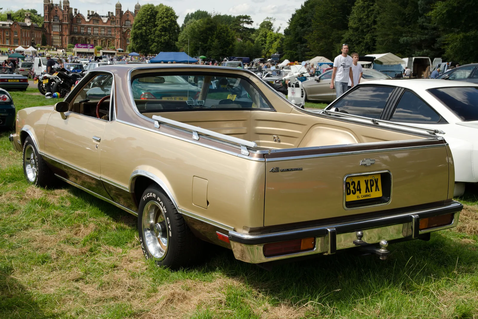 Gold 1985 Chevrolet El Camino viewed from the rear at a classic-car show.